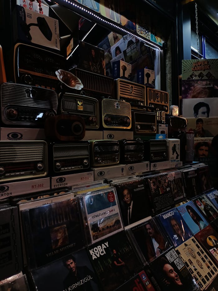 Explore a retro music store with vintage radios and a diverse CD collection in a nostalgic setting.